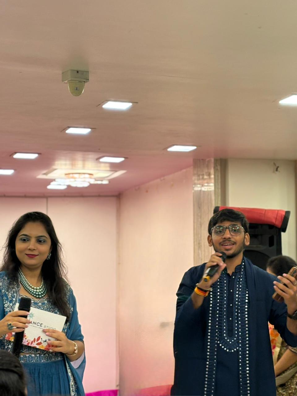 Corporate event stage with lighting and hosting setup